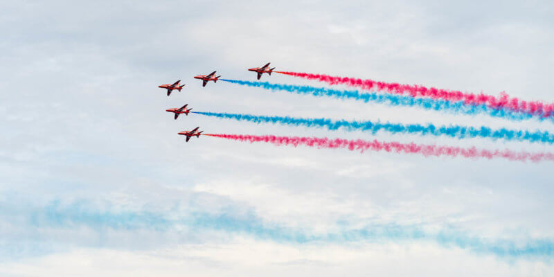 red arrows flying with iconic smoke coming out