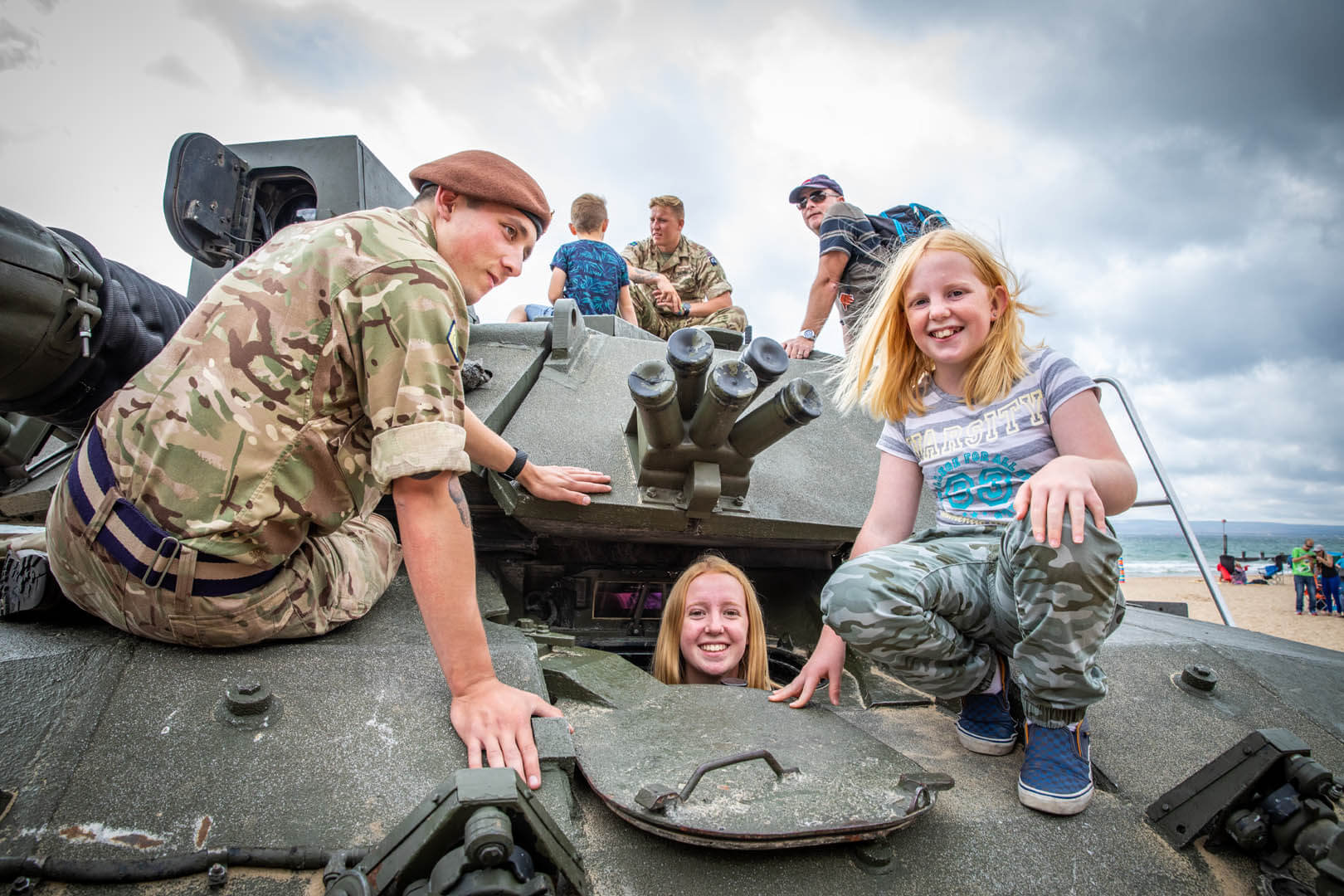 Two girls exploring the tank with a British soldier at the Bournemouth Air festival