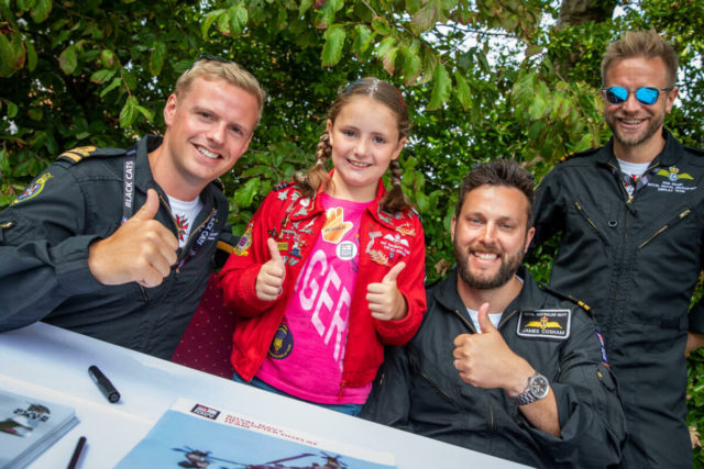 Thumbs up from Royal Air Force pilots and a young fan at the meet and greet event