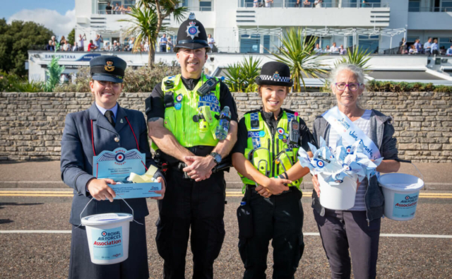 Two police officers having a photo with two royal air force charity members