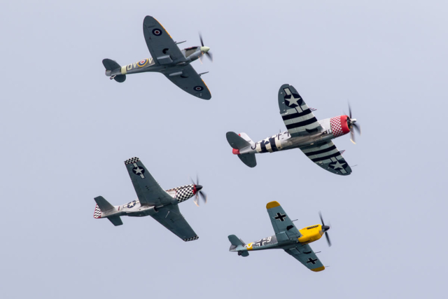 4 warbird planes flying in formation during their air show performance