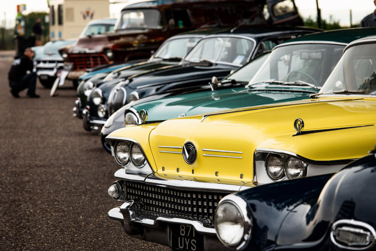 vintage cars lined up in a row